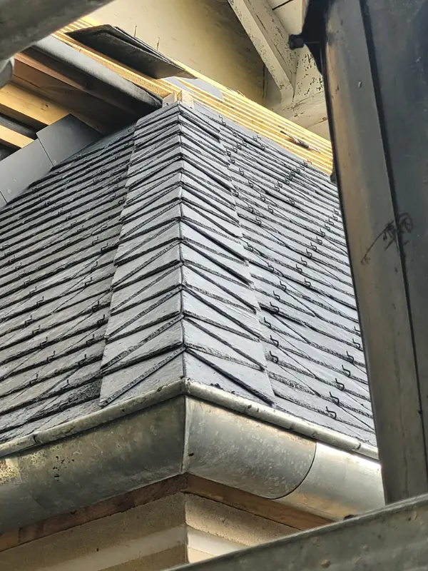 finition tuiles de rives sur une toiture en ardoise à Esquerdes